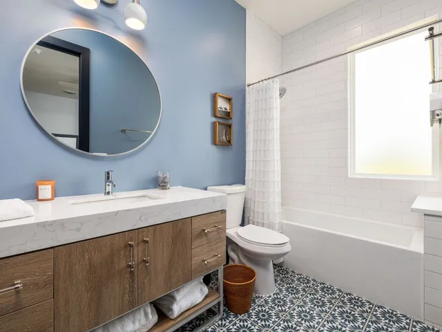 a bathroom with a toilet a sink and mirror
