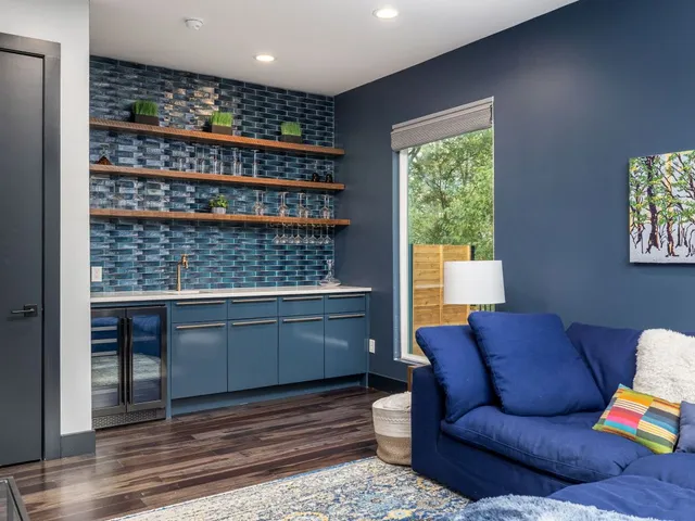 a living room with furniture a window and bookshelf