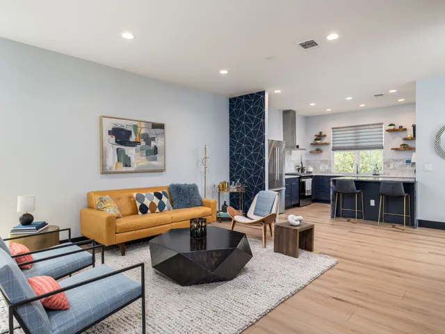 a living room with furniture and a wooden floor