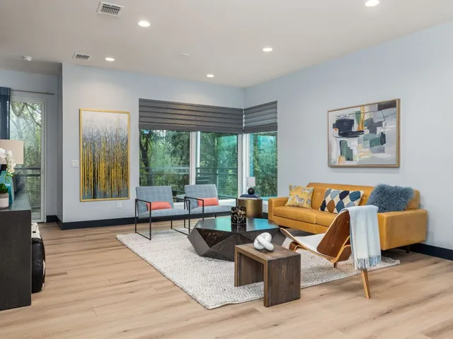 a living room with furniture and floor to ceiling window