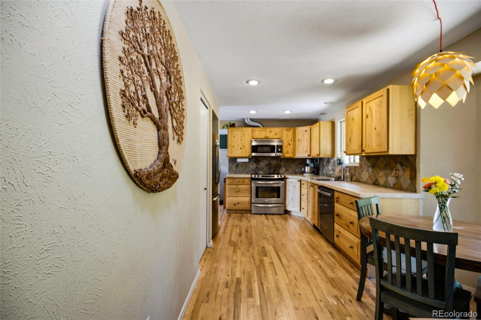 31280 Florence Road Conifer, CO 80433 - Photo 17 of 48 a kitchen with stainless steel appliances granite countertop a stove a sink a microwave and living room view