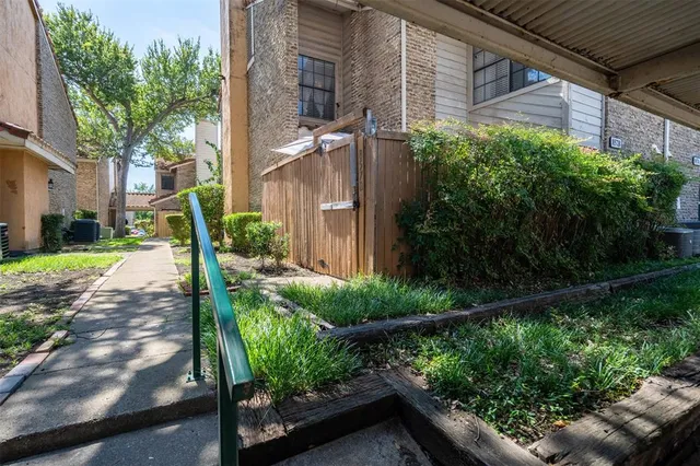 a living room with furniture a flat screen tv and a window