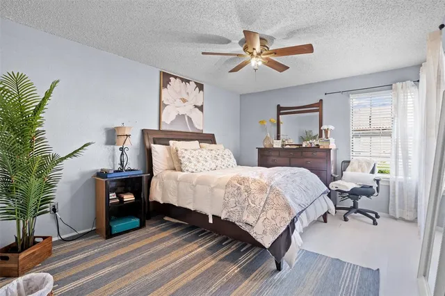 a bedroom with a bed and a painting on the wall