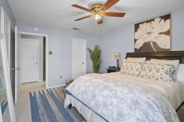 a bedroom with bed and a chandelier