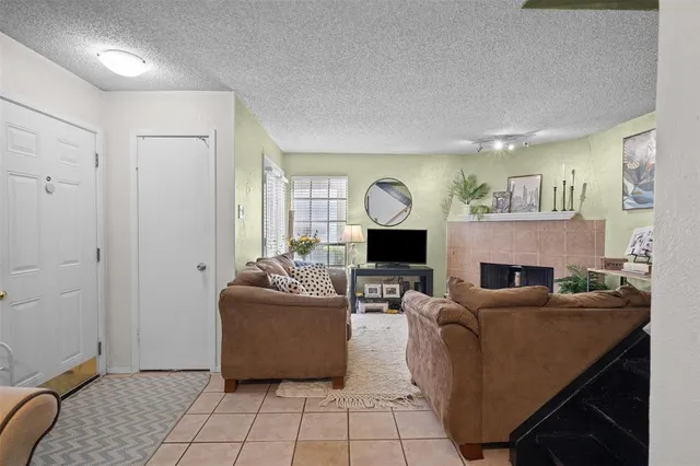 a living room with fireplace furniture and a window