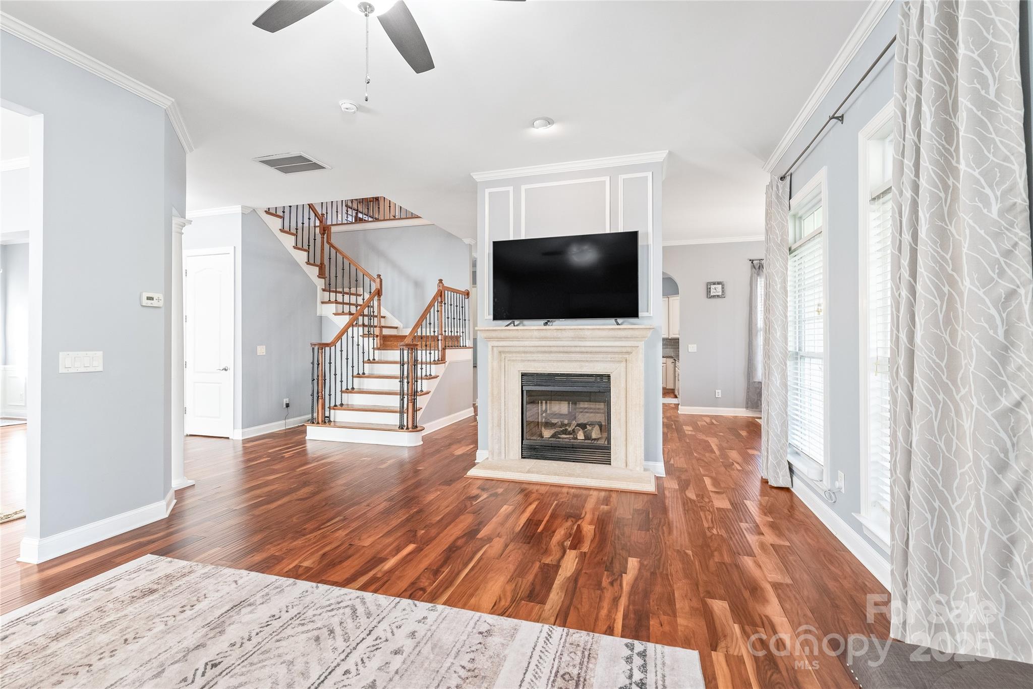 8504 Soaring Eagle Lane Waxhaw, NC 28173 - Photo 11 of 48 a living room with furniture a flat screen tv and a fireplace