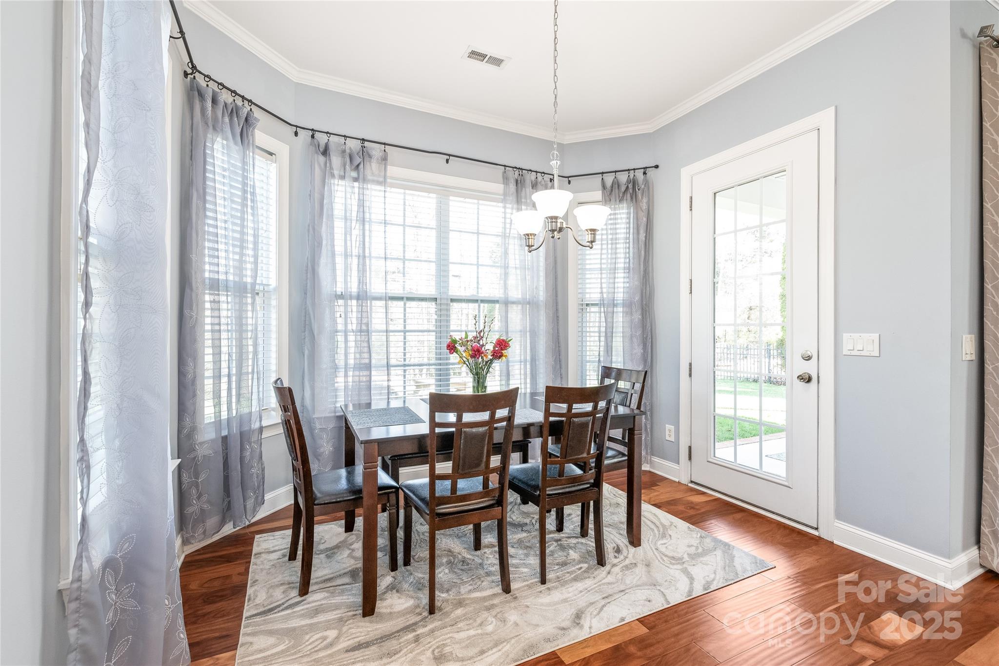 8504 Soaring Eagle Lane Waxhaw, NC 28173 - Photo 14 of 48 a view of a dining room with furniture and wooden floor