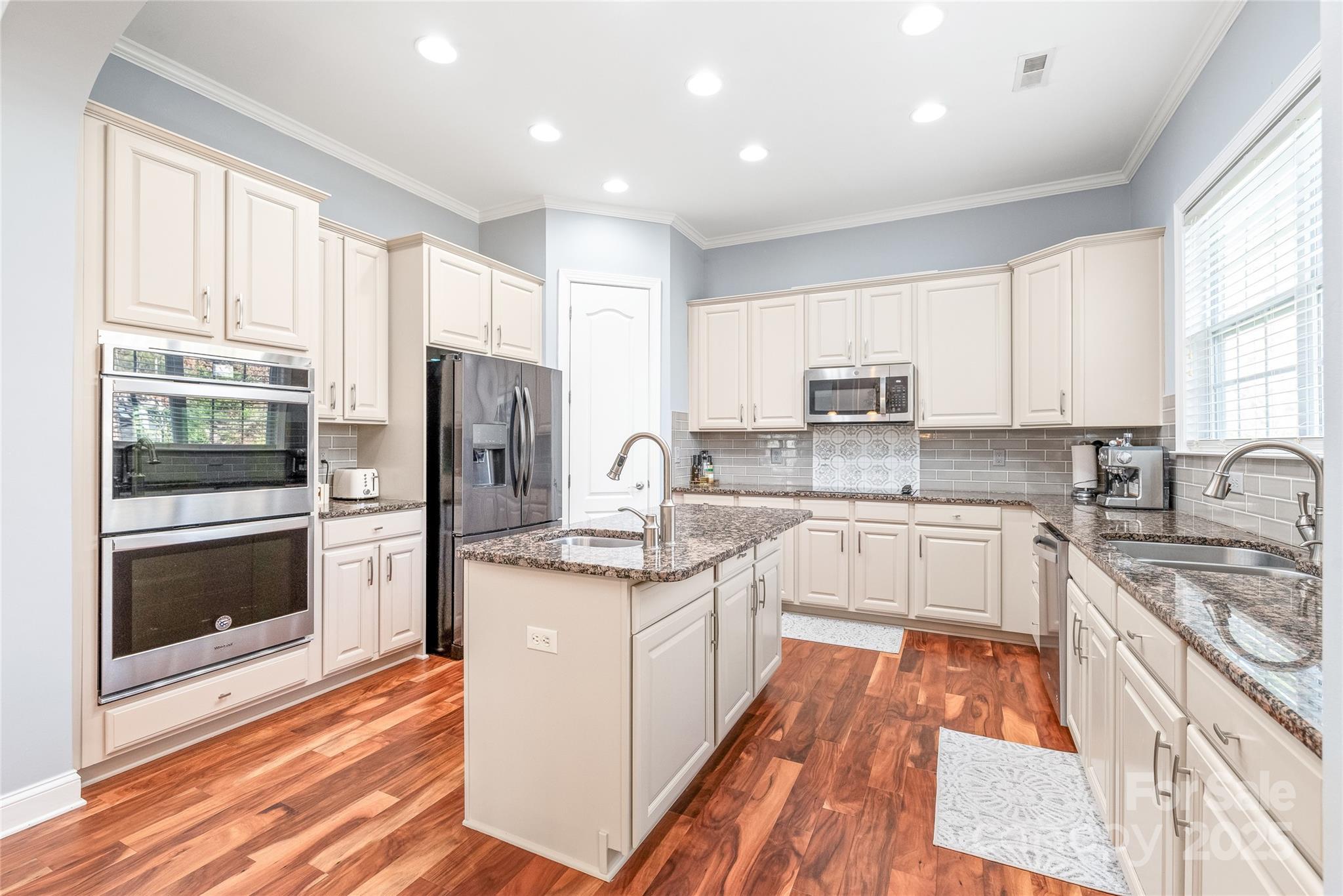 8504 Soaring Eagle Lane Waxhaw, NC 28173 - Photo 16 of 48 a kitchen with stainless steel appliances granite countertop a refrigerator stove and sink