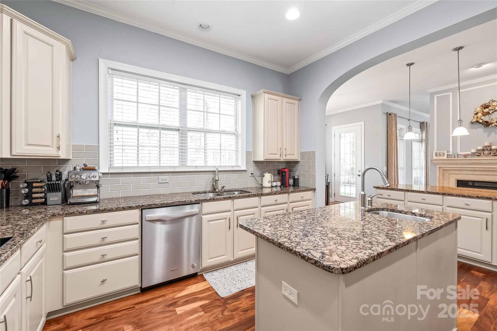 8504 Soaring Eagle Lane Waxhaw, NC 28173 - Photo 18 of 48 a kitchen with granite countertop kitchen island wooden cabinets and center island