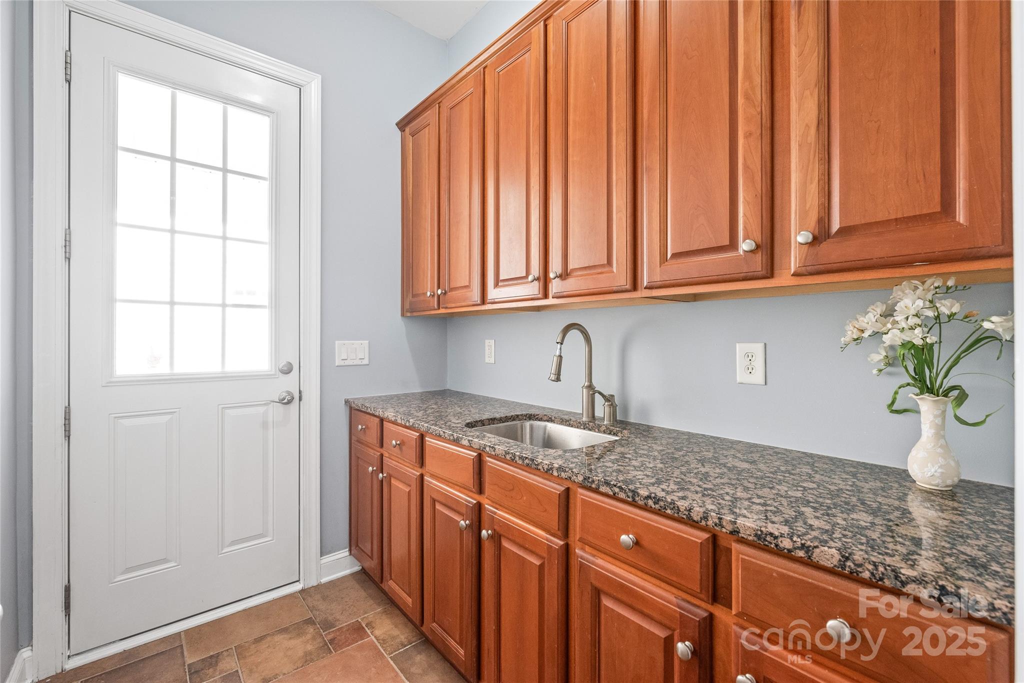 8504 Soaring Eagle Lane Waxhaw, NC 28173 - Photo 20 of 48 a kitchen with stainless steel appliances granite countertop wooden cabinets a sink and a window