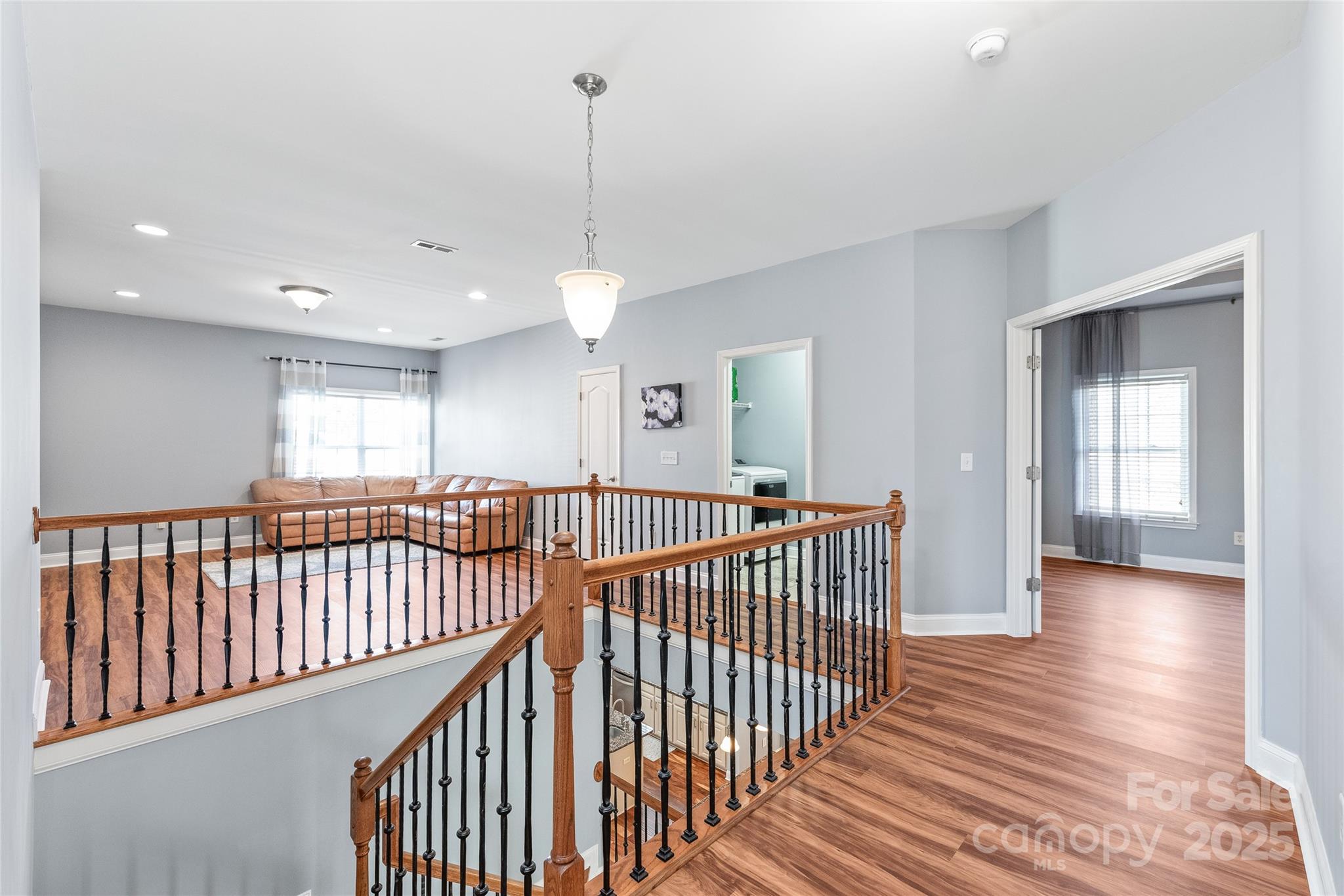 8504 Soaring Eagle Lane Waxhaw, NC 28173 - Photo 23 of 48 a view of a hallway with wooden floor and windows