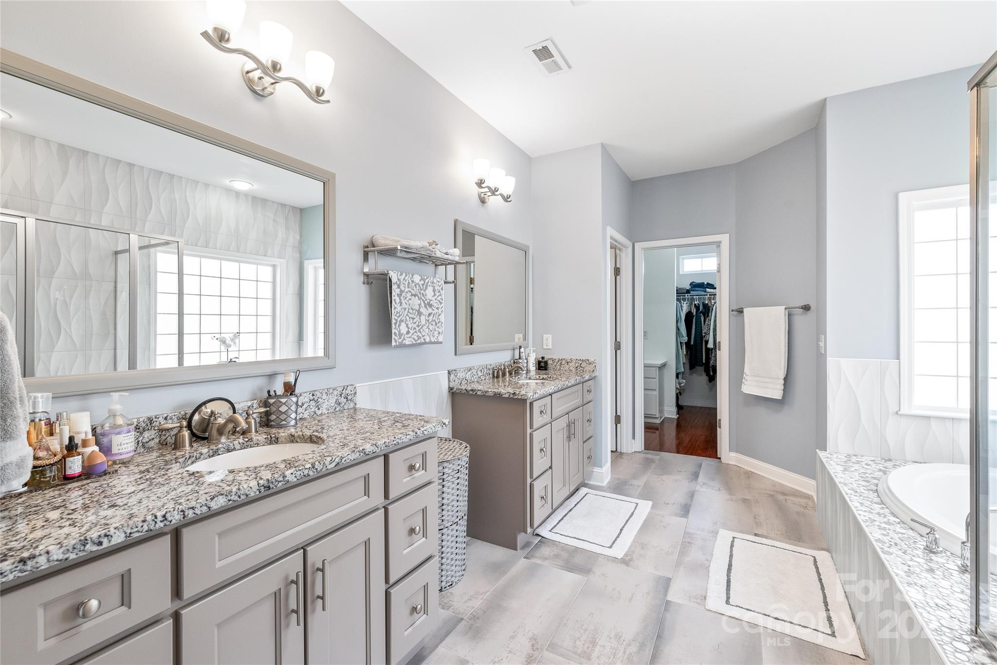 8504 Soaring Eagle Lane Waxhaw, NC 28173 - Photo 26 of 48 a spacious bathroom with a granite countertop sink mirror and shower