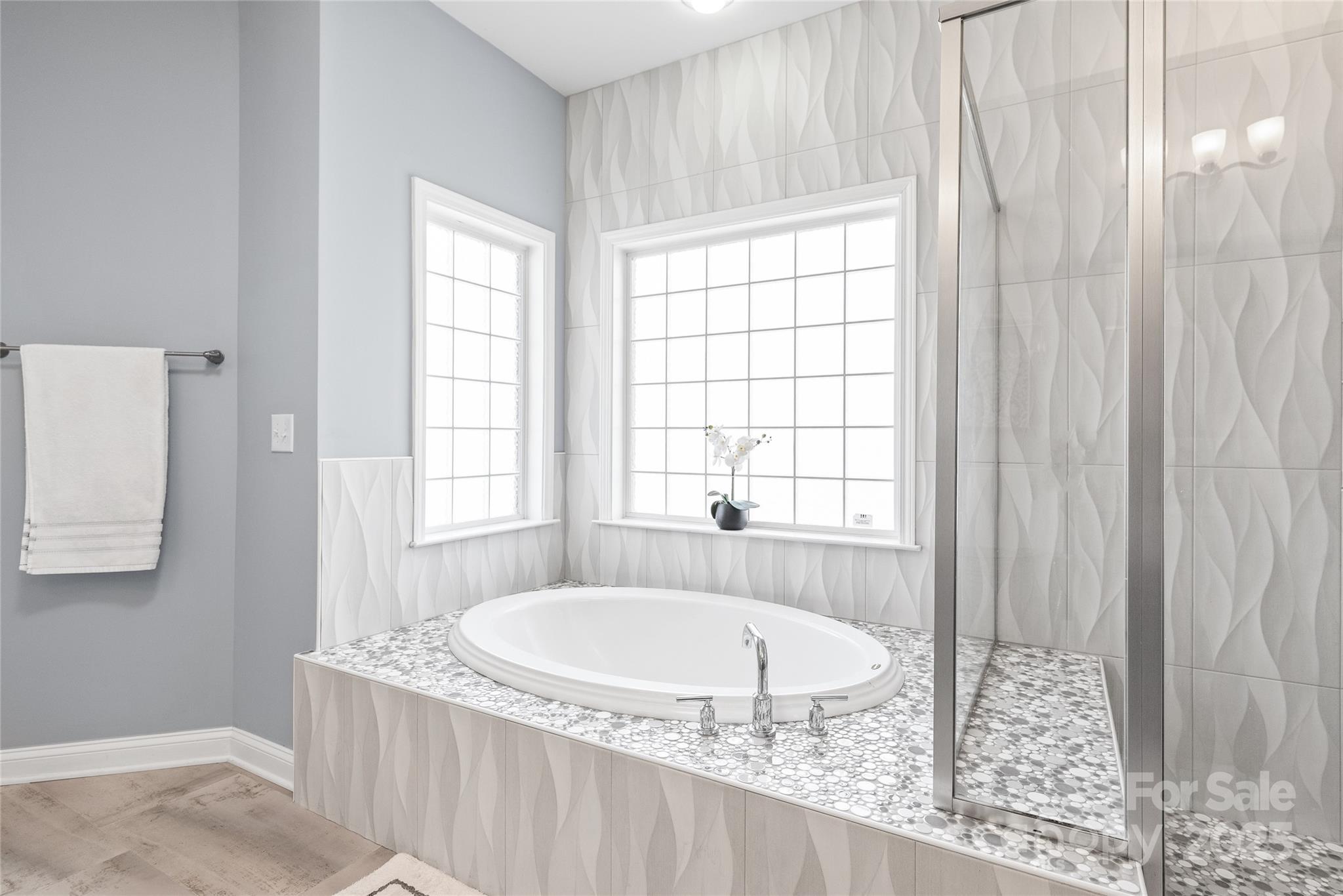 8504 Soaring Eagle Lane Waxhaw, NC 28173 - Photo 27 of 48 a bathroom with a tub and window