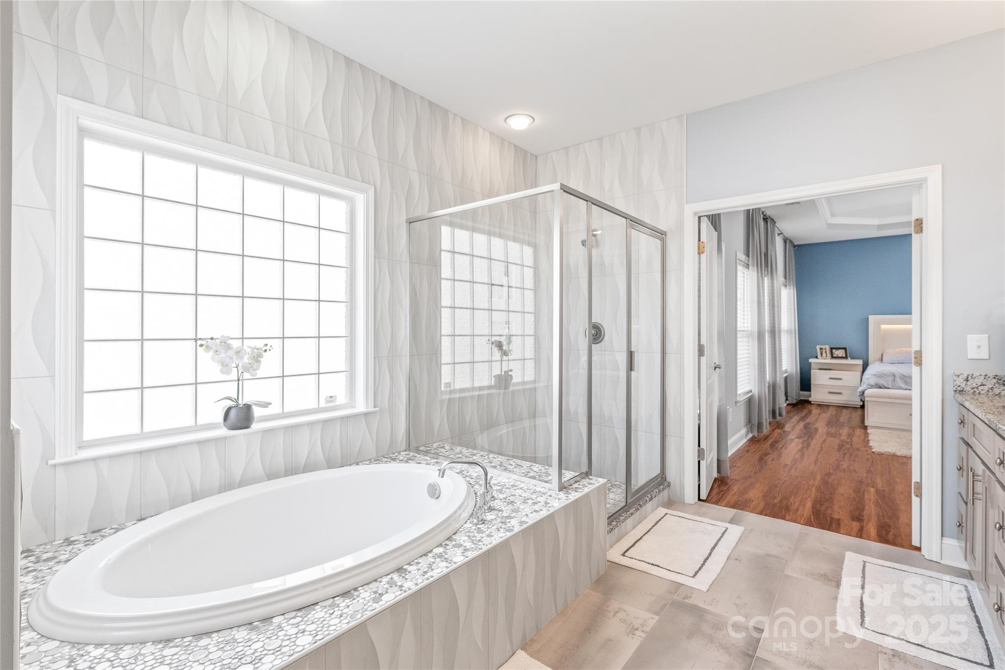 8504 Soaring Eagle Lane Waxhaw, NC 28173 - Photo 28 of 48 a spacious bathroom with a tub and large window