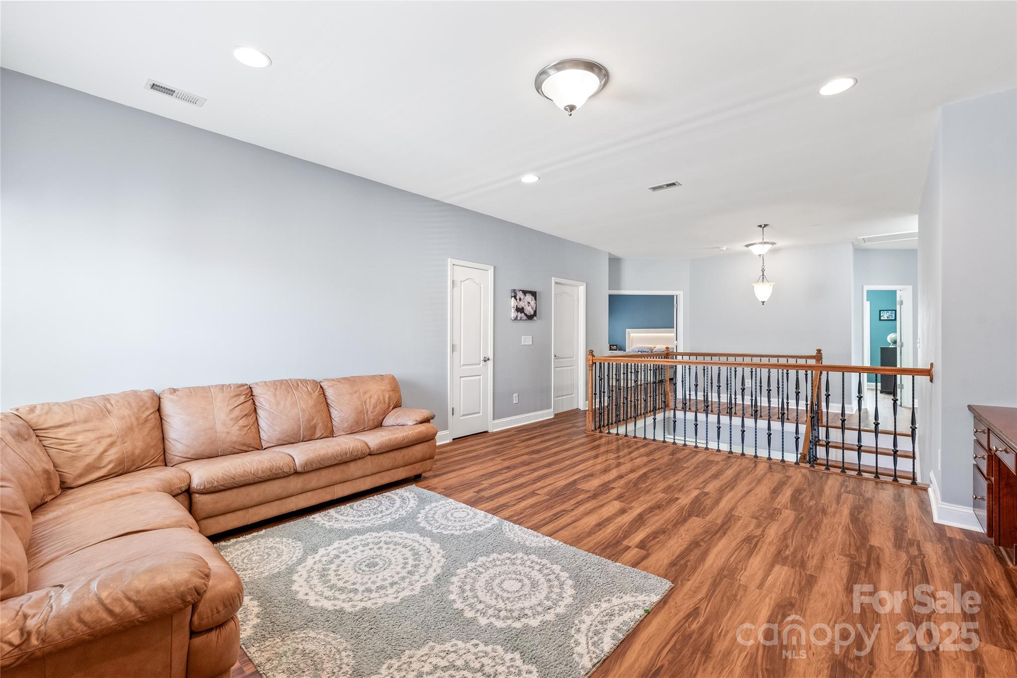 8504 Soaring Eagle Lane Waxhaw, NC 28173 - Photo 32 of 48 a living room with a couch and a wooden floor