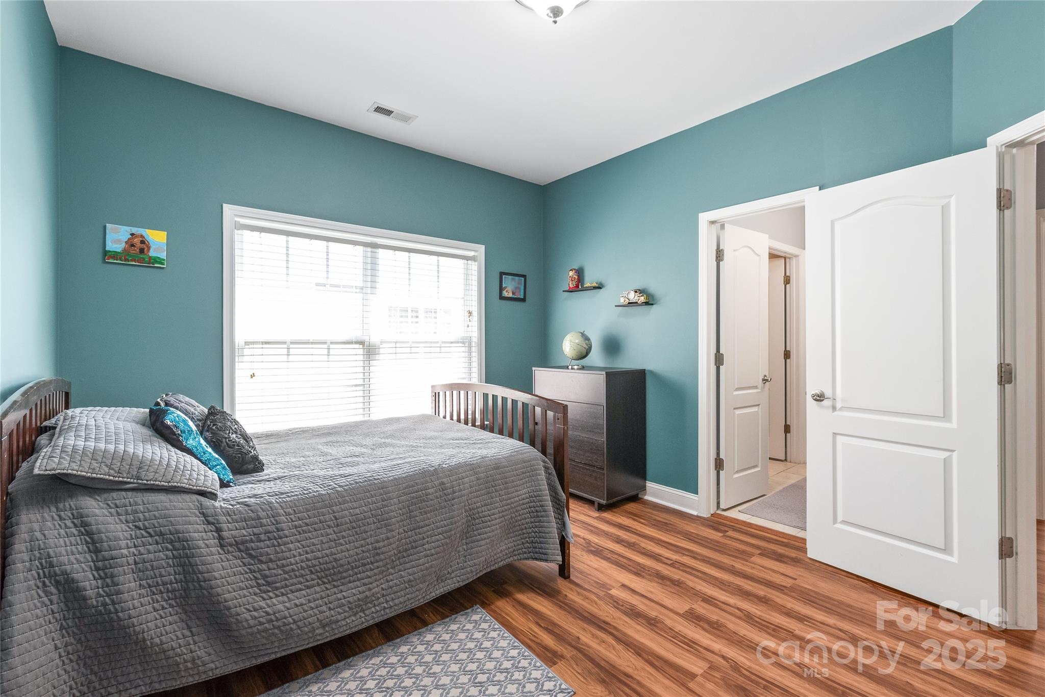 8504 Soaring Eagle Lane Waxhaw, NC 28173 - Photo 38 of 48 a bedroom with a bed and wooden floor
