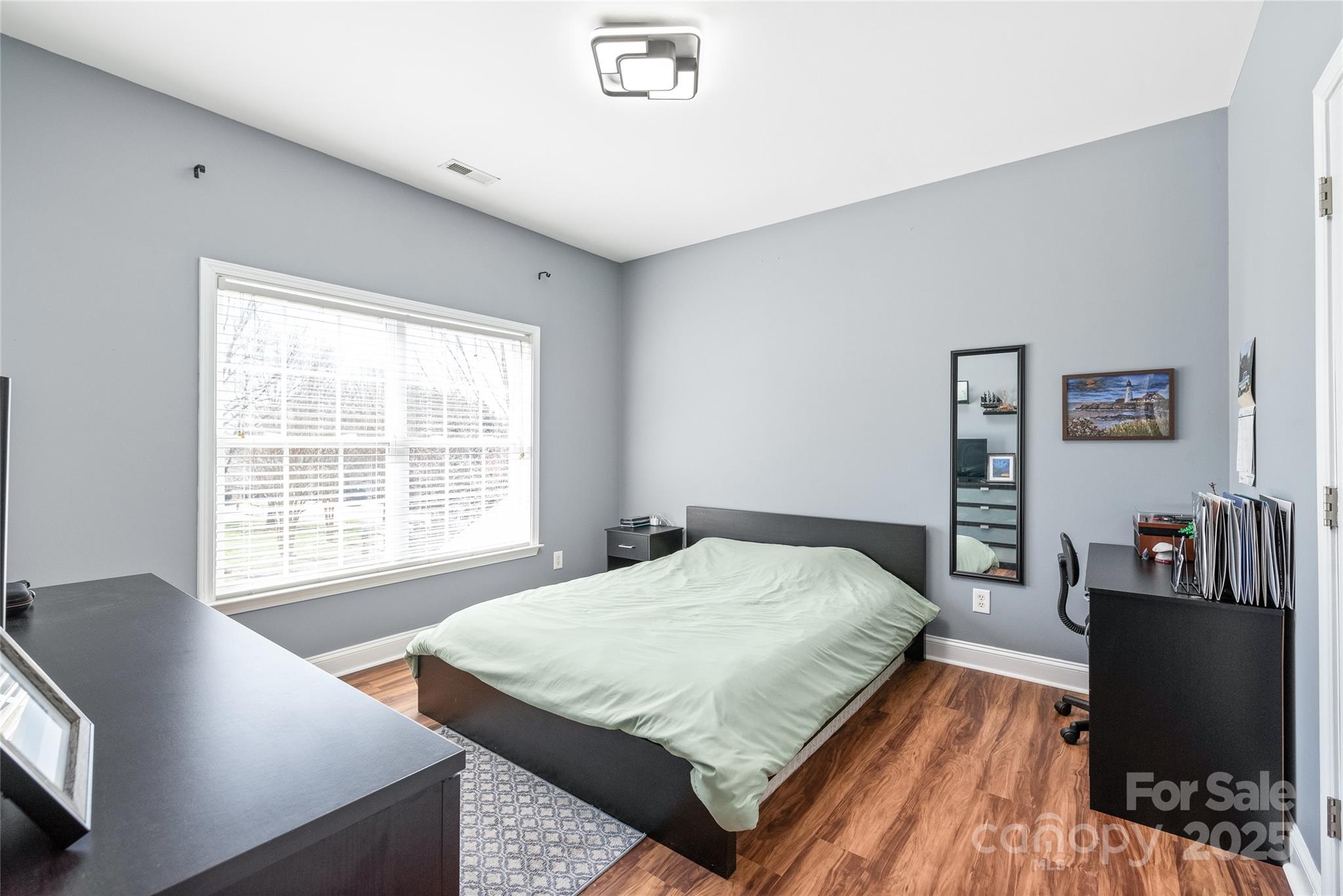 8504 Soaring Eagle Lane Waxhaw, NC 28173 - Photo 39 of 48 a bedroom with a bed and wooden floor