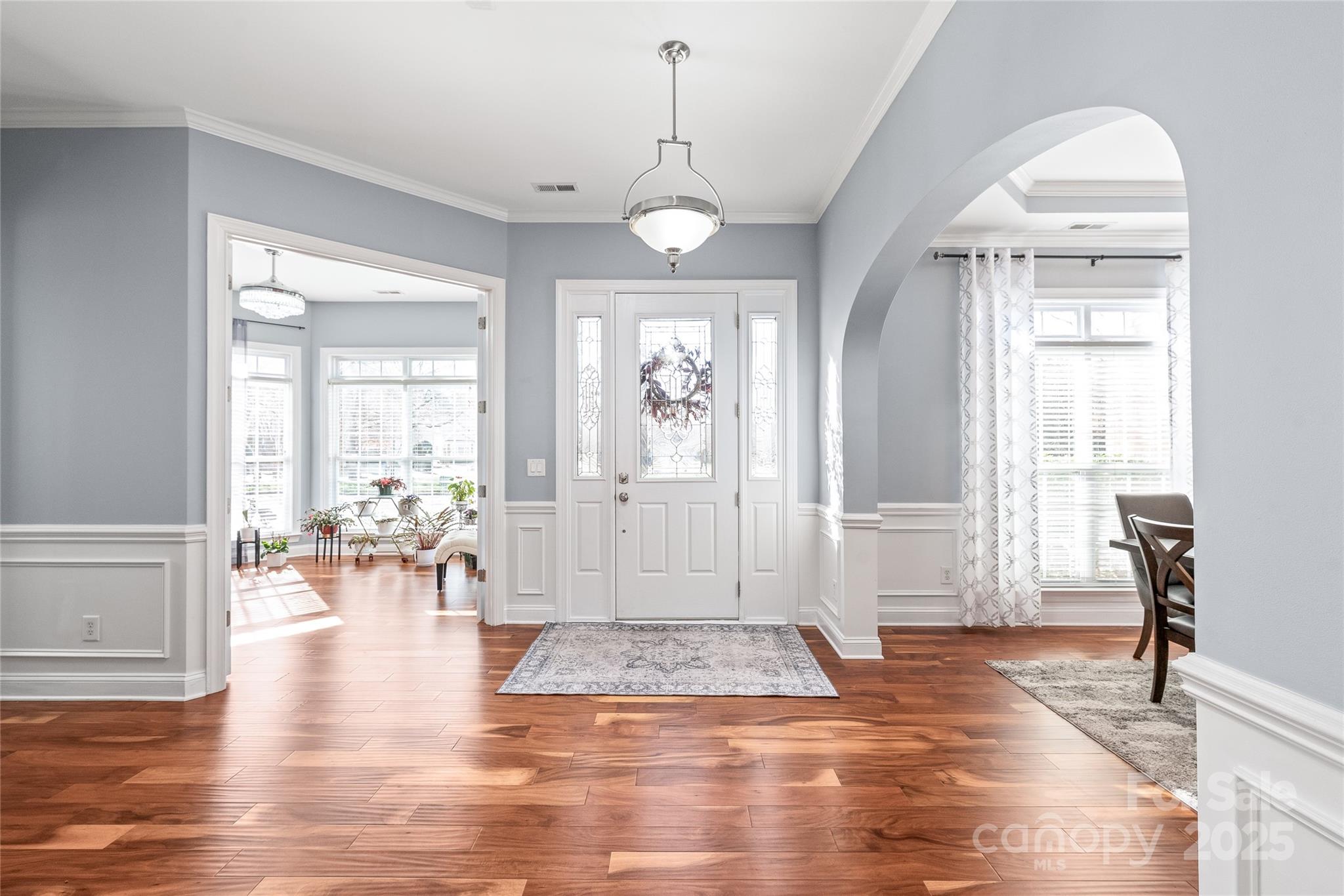 8504 Soaring Eagle Lane Waxhaw, NC 28173 - Photo 4 of 48 a view of a livingroom with wooden floor and a chandelier