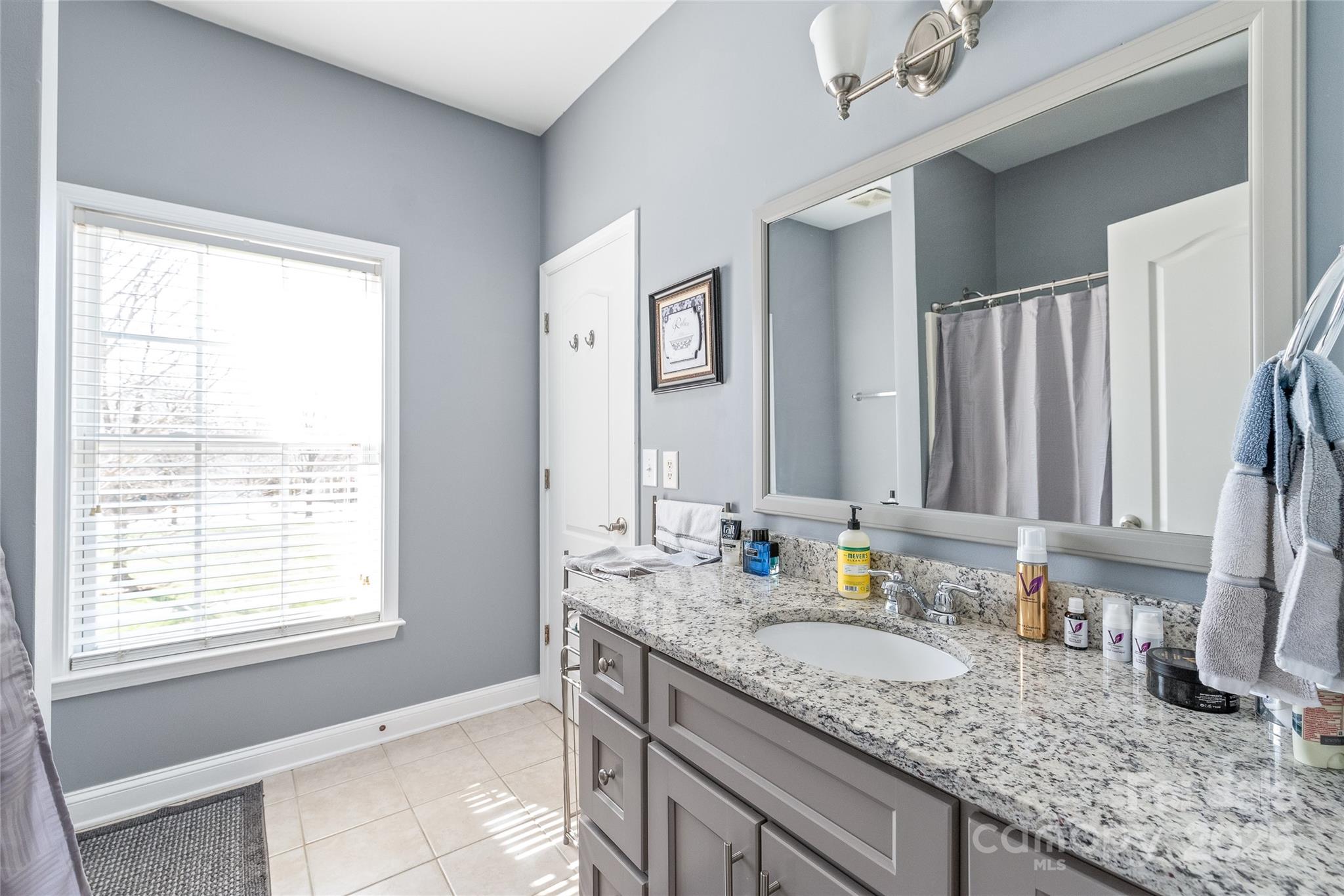 8504 Soaring Eagle Lane Waxhaw, NC 28173 - Photo 41 of 48 a bathroom with a granite countertop sink and a window