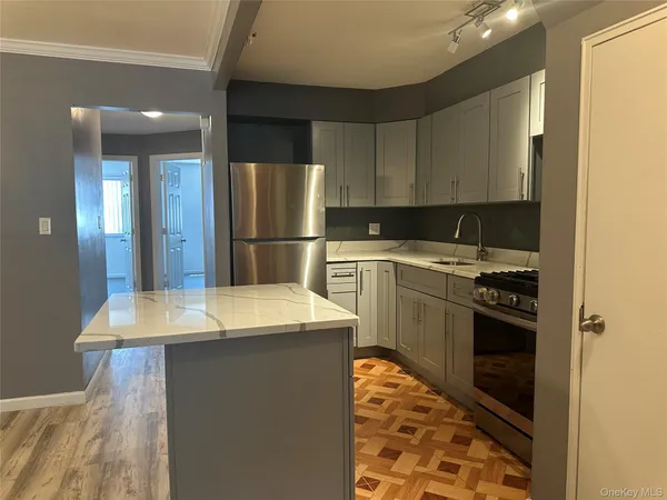 a kitchen that has a sink and a stove in it