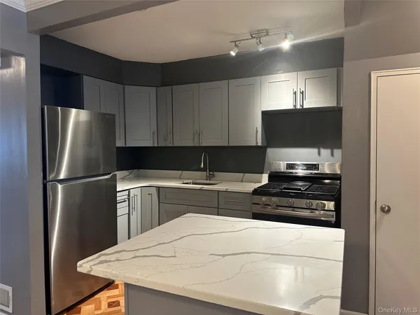 a kitchen with a refrigerator and a stove top oven