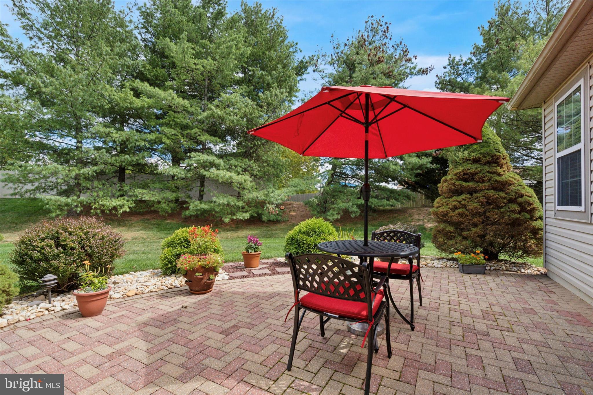 1518 Springfield Court, Unit 30 Jamison, PA 18929 - Photo 21 of 23 an outdoor sitting area with red umbrella and barbeque oven