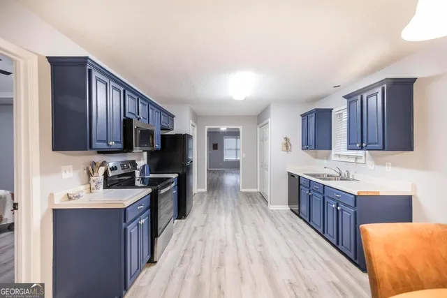 a kitchen with stainless steel appliances granite countertop wooden cabinets a stove top oven a sink and dishwasher