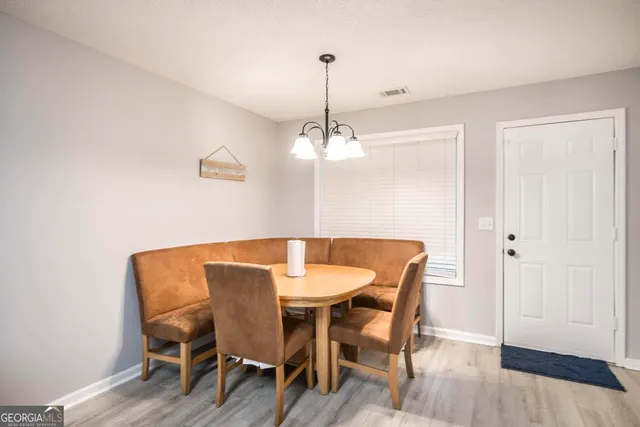 a dining room with furniture and wooden floor