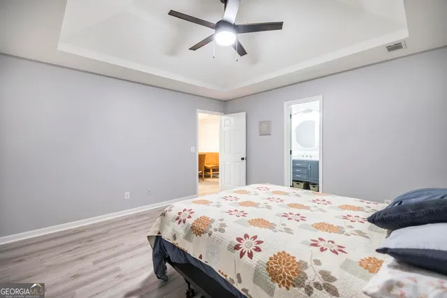 a bedroom with a bed and a chandelier