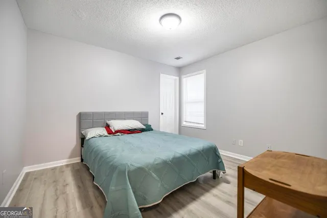 a bedroom with a bed and a table