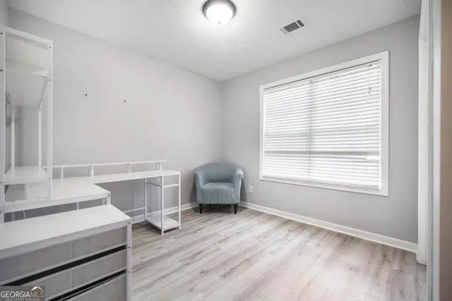 a living room with a bed furniture and a window