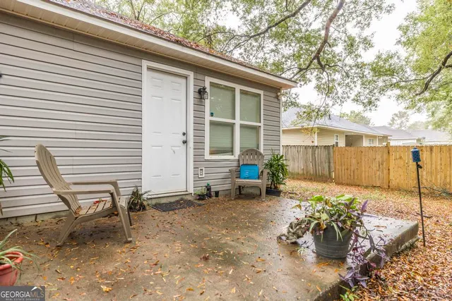 a view of a chair and table in backyard