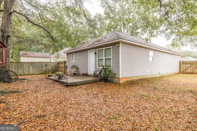 a view of a house with backyard and sitting area