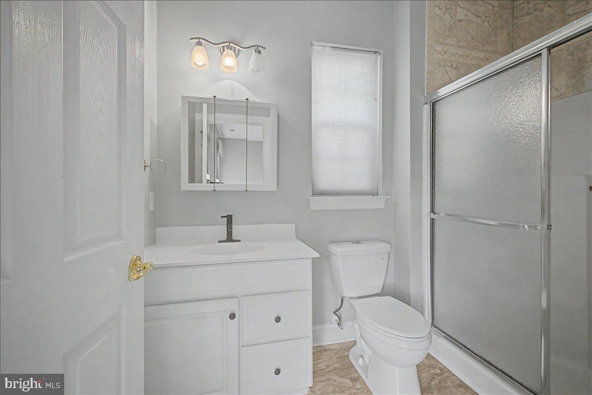 12 Springmill Drive Middletown, DE 19709 - Photo 21 of 31 a bathroom with a toilet sink vanity and mirror