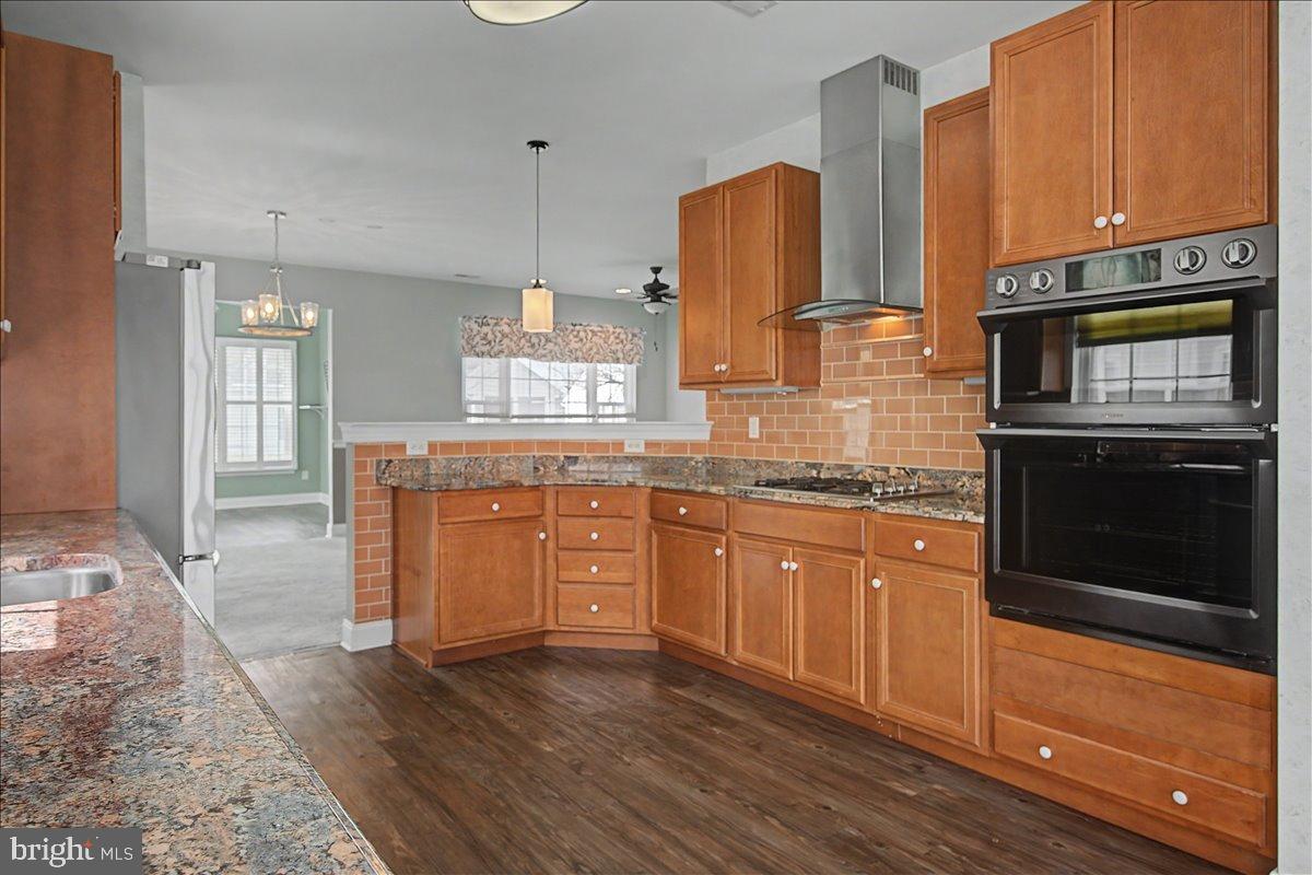 12 Springmill Drive Middletown, DE 19709 - Photo 8 of 31 a kitchen with granite countertop wooden cabinets stainless steel appliances and a counter space