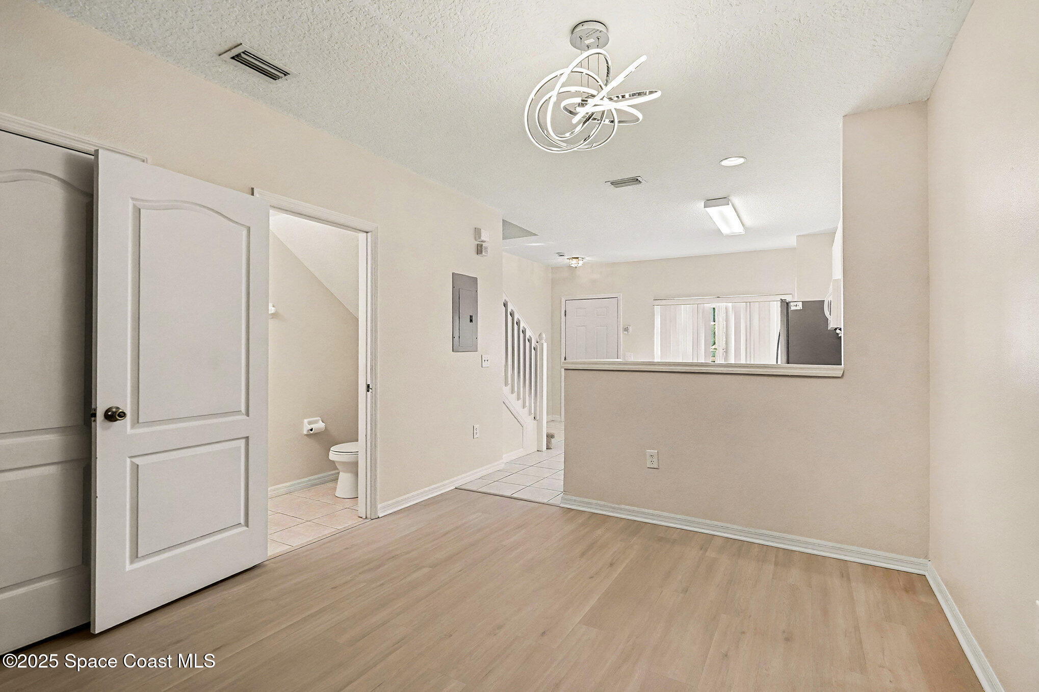1352 Hampton Park Lane Melbourne, FL 32940 - Photo 5 of 15 a view of empty room with wooden floor and window
