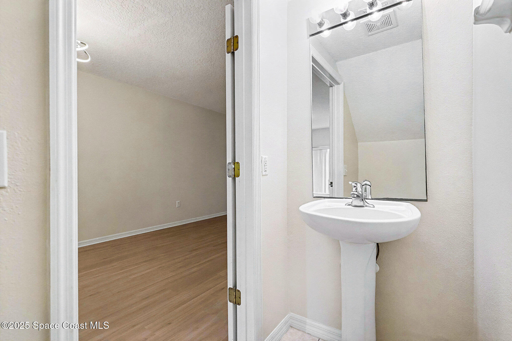 1352 Hampton Park Lane Melbourne, FL 32940 - Photo 9 of 15 a bathroom with a sink a mirror and shower