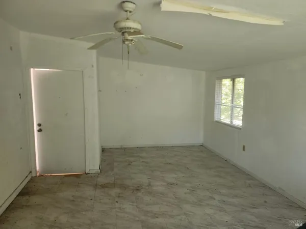 an empty room with windows and closet
