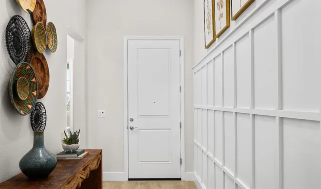 a bedroom with a bed table and a potted plant