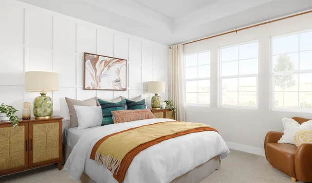 a bedroom with a bed and a large window