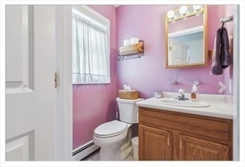 65 Camden Street, Unit 1 Lynn, MA 01905 - Photo 12 of 14 a bathroom with a granite countertop toilet sink and mirror