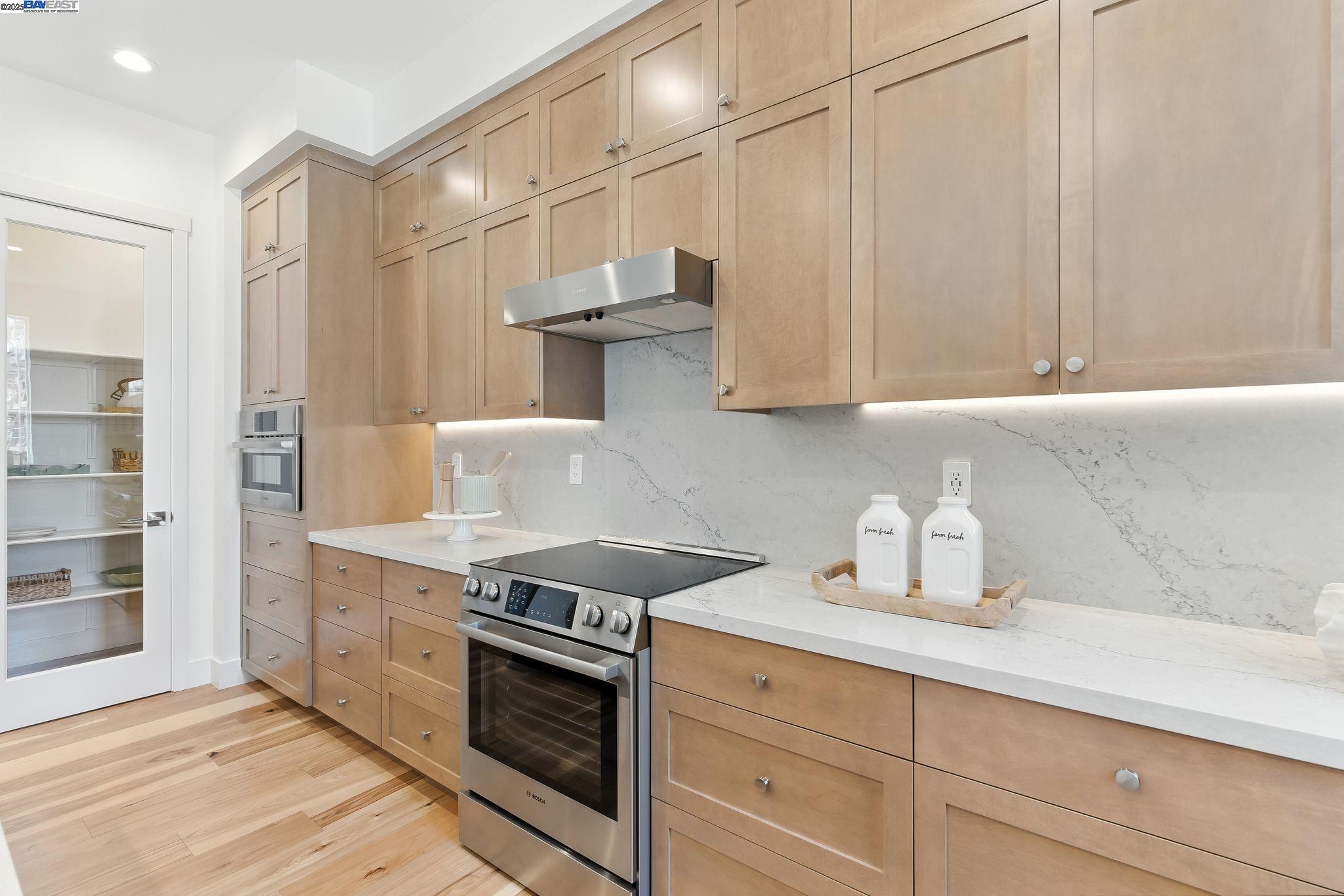 1937 Grand Street Alameda, CA 94501 - Photo 13 of 29 a kitchen with stainless steel appliances granite countertop a sink a stove and a refrigerator