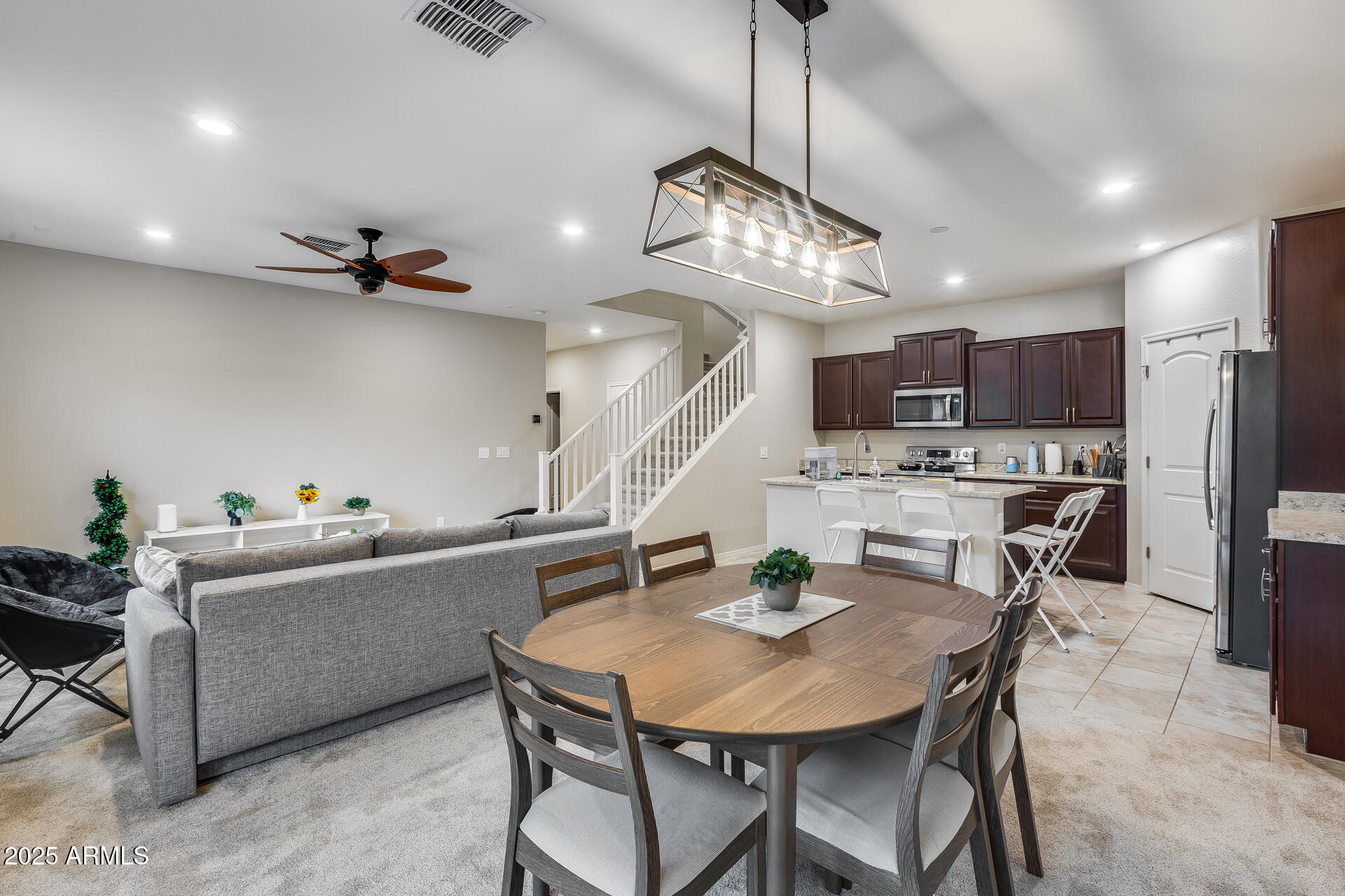 6853 East Posada Circle Mesa, AZ 85212 - Photo 13 of 45 a view of a dining room with furniture and a chandelier