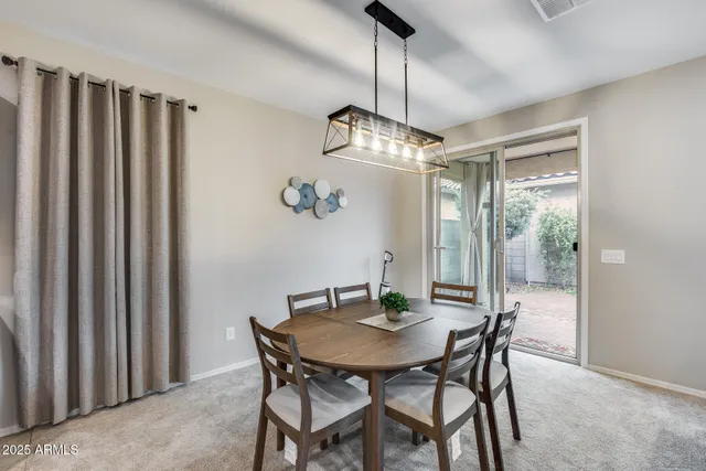 a view of a dining room with furniture and a chandelier