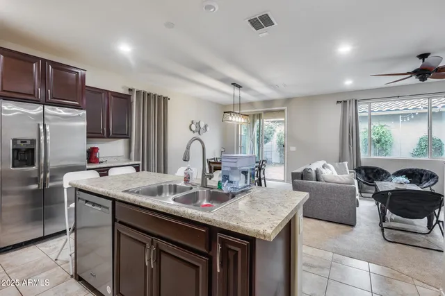 a kitchen with granite countertop a table chairs stove and kitchen view