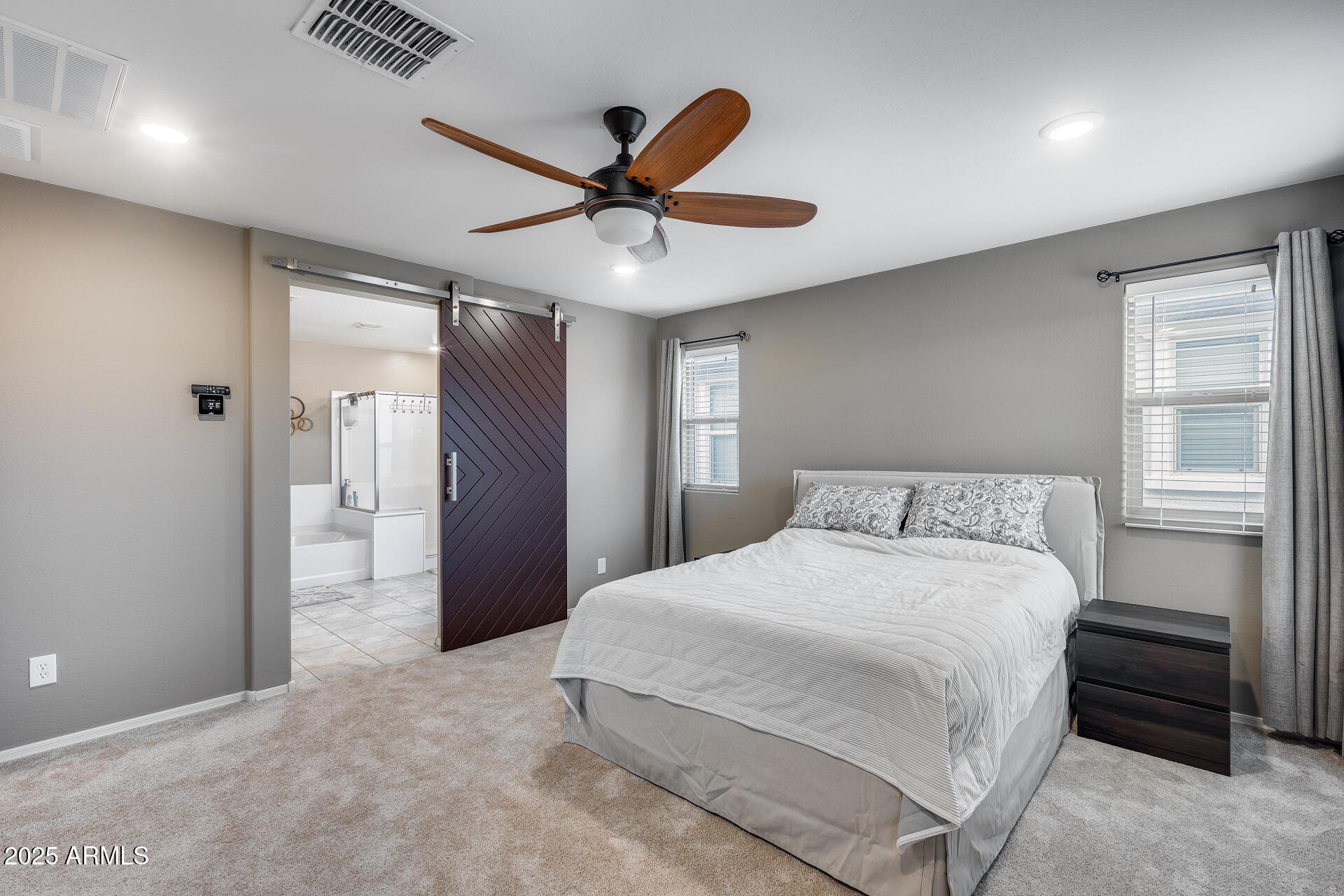 6853 East Posada Circle Mesa, AZ 85212 - Photo 24 of 45 a bedroom with a large bed and a chandelier