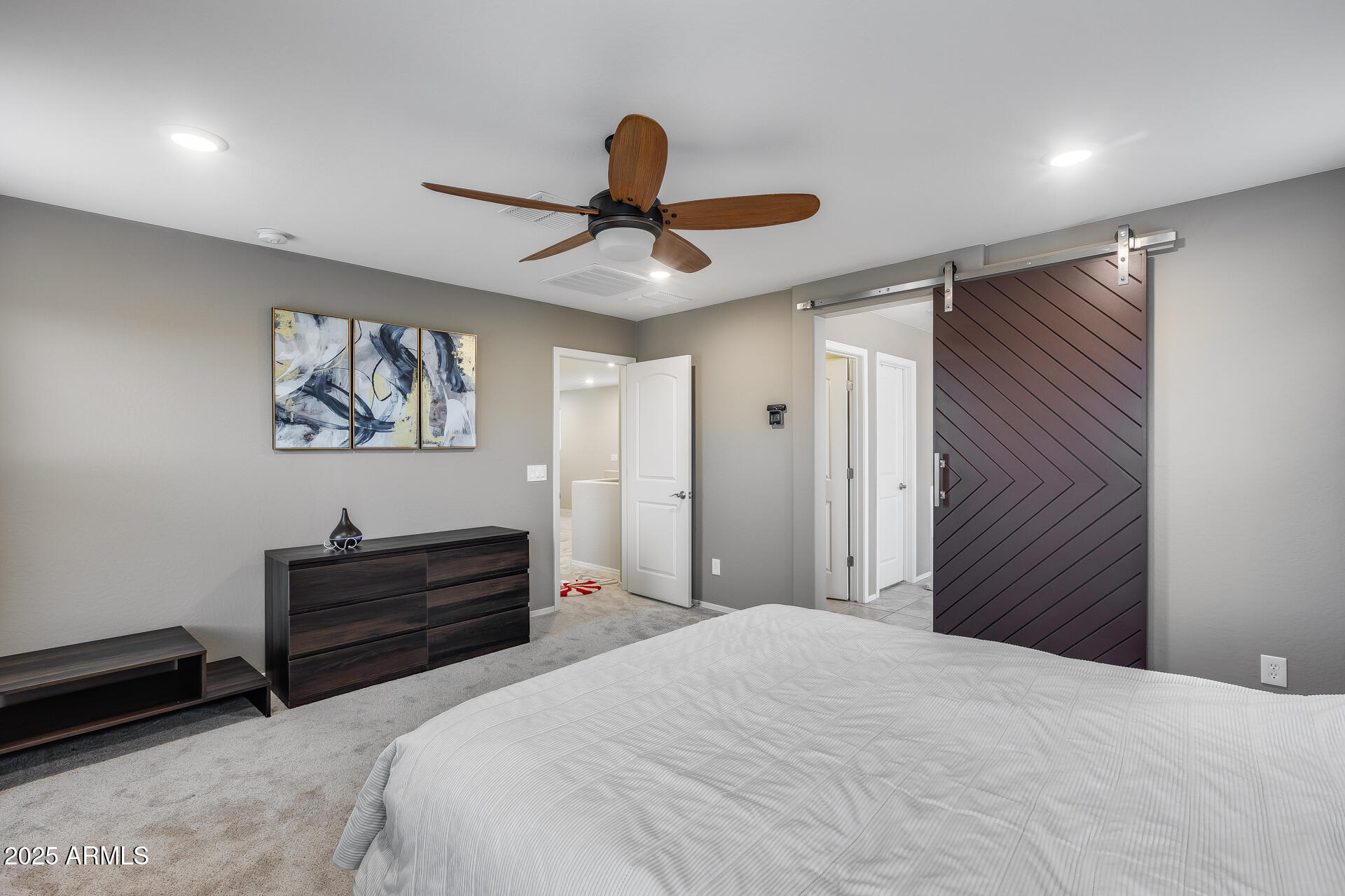 6853 East Posada Circle Mesa, AZ 85212 - Photo 25 of 45 a bedroom with a bed and a chandelier