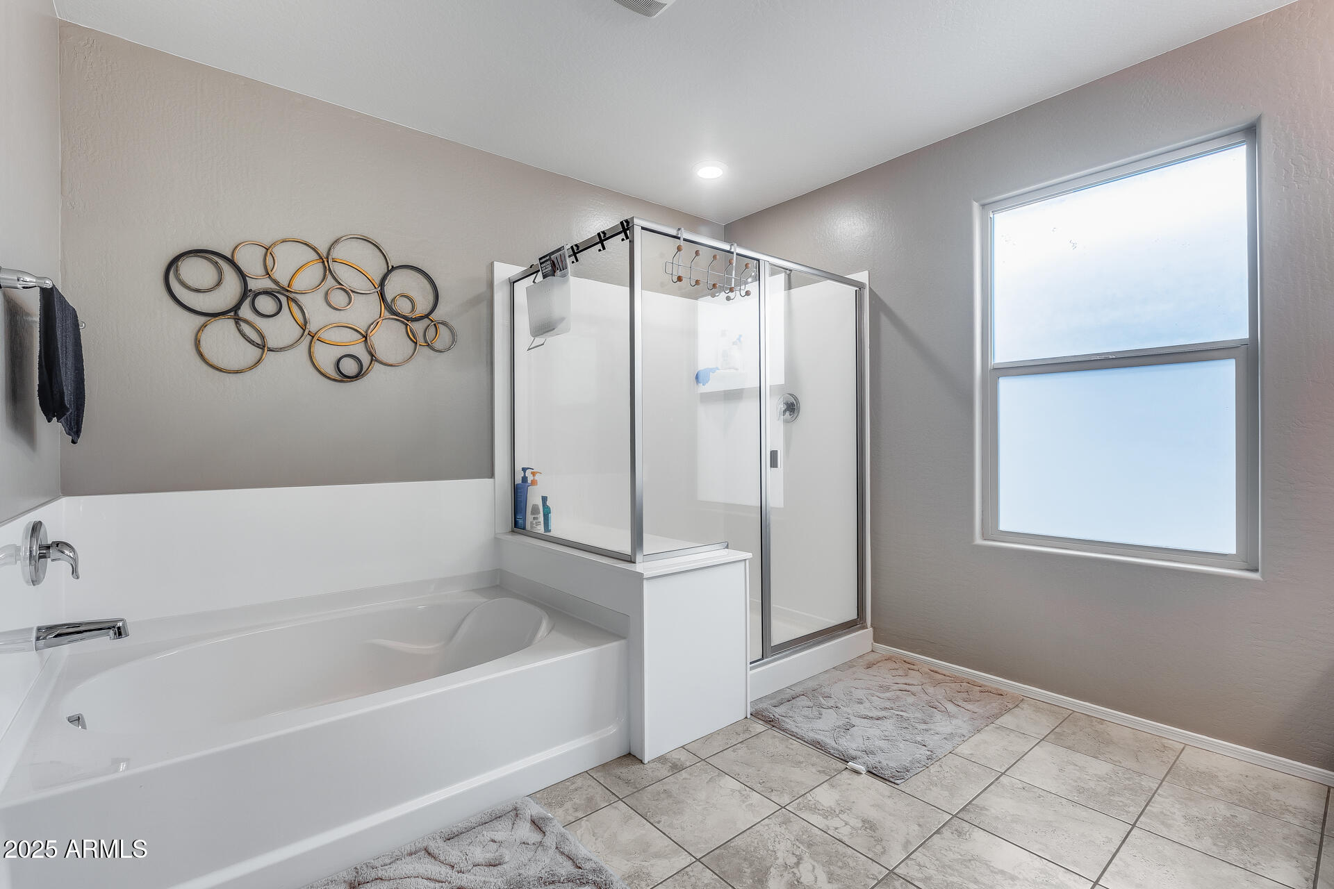 6853 East Posada Circle Mesa, AZ 85212 - Photo 26 of 45 a bathroom with a bathtub and a shower