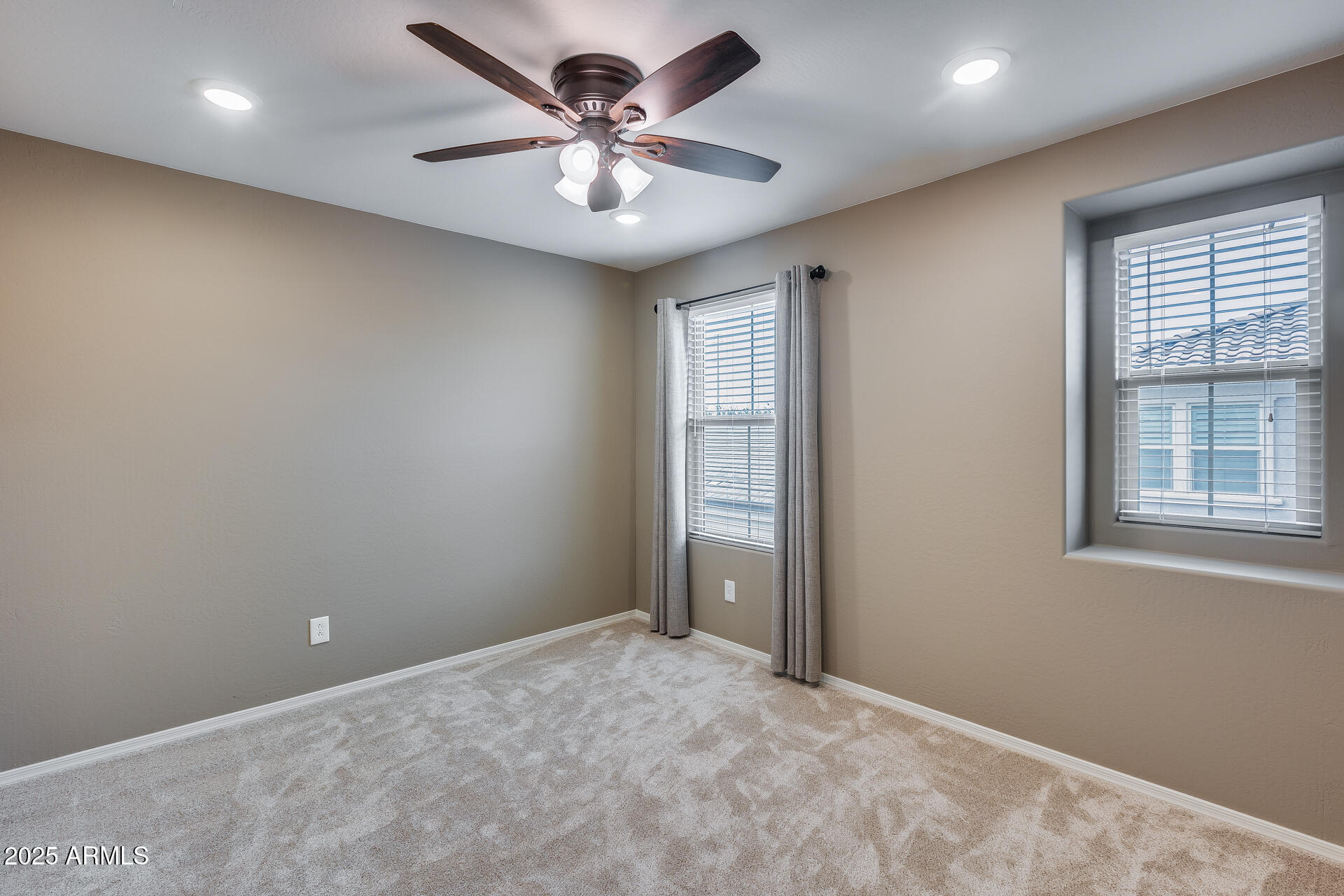 6853 East Posada Circle Mesa, AZ 85212 - Photo 29 of 45 an empty room with windows and fan