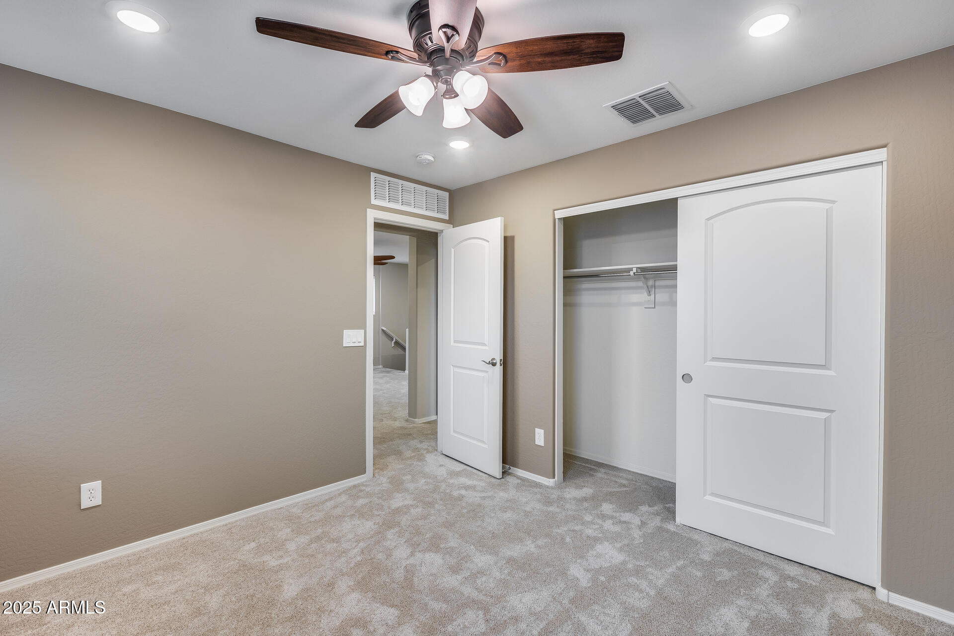 6853 East Posada Circle Mesa, AZ 85212 - Photo 31 of 45 an empty room with closet and a ceiling fan